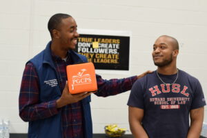 Jerron, alumni, and Edward Burroughs stand next to each other